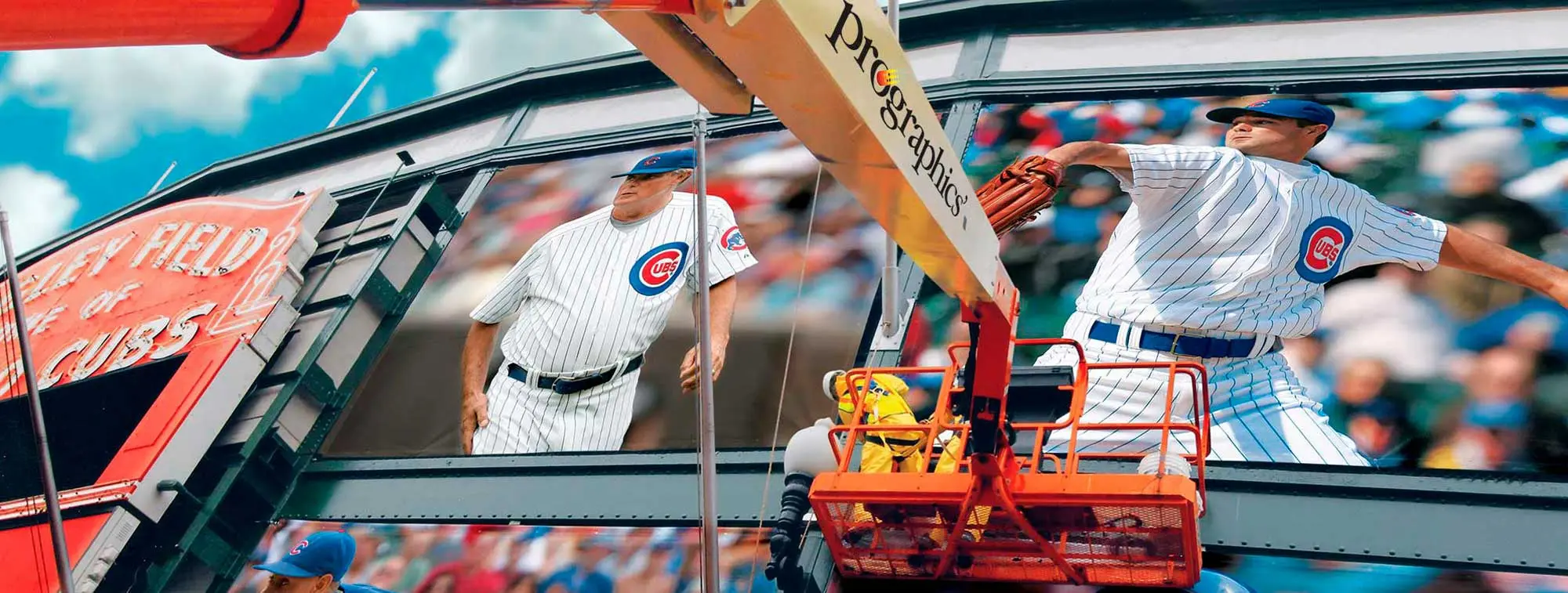 Prographics crew installing Chicago Cubs graphics from a lift